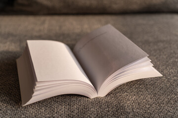 open book on the grey couch