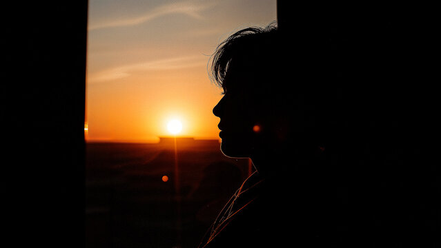 Silhouette reflection of sunset in window view