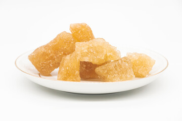 Brown sugar or crystalline sugar lumps isolated on white background.
