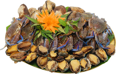 A fresh seafood platter featuring oysters, shrimp, and crab claws. Top view of assorted seafood in plate