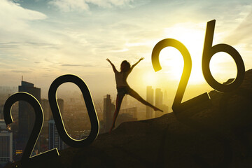 Joyful Leap into 2026 – Woman Celebrating New Year on City Skyline at Sunrise