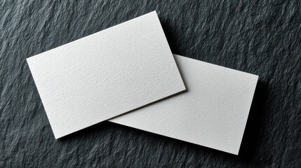 Blank business cards on dark stone