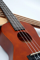 Obraz premium Four-string bass ukulele with wooden body and built-in tuner and pickup.