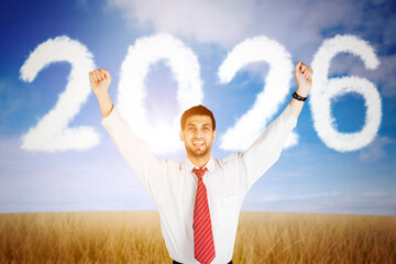 Happy Businessman Celebrating New Year 2026 with Cloud Numbers in the Sky