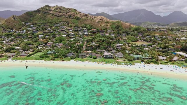 Lanikai Beach, Oahu Island, Hawaii USA. Drone Shot of White Sand, Turquoise Ocean, Beachfront Homes and Parasailing Parachute