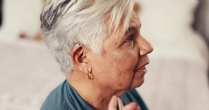 Healthcare, nurse and helping old woman with hearing aid, nursing home or installation of equipment. Happy, caregiver and assistance for elderly person with tech to amplify sound and communication