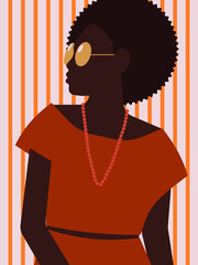 Fashionable and stylish woman in orange dress with beads and sunglasses on striped background posing portrait. 
