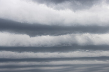 Layered clouds indicating impending heavy rainfall—an extreme weather phenomenon associated with...