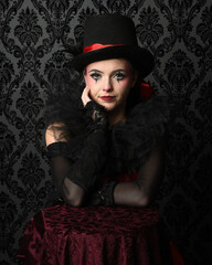 Close-up  glamour portrait of circus burlesque model wearing top hat and gothic gloves, theatrical...
