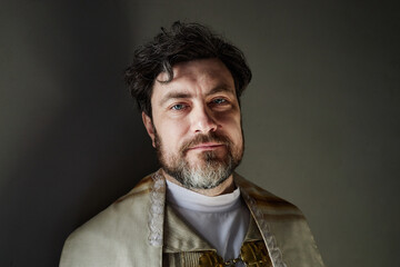Portrait of middle aged Caucasian man wearing clerical vestments standing in church, looking...