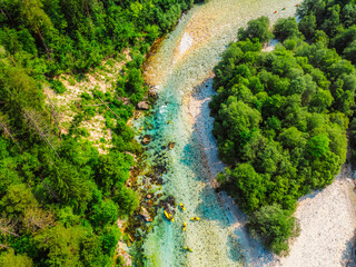 Rafting and kayaking place on the river. Kayakers in colorful life jacket paddling in Soca river,...