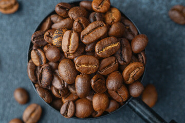 Macro shot of coffee beans in measuring spoon
