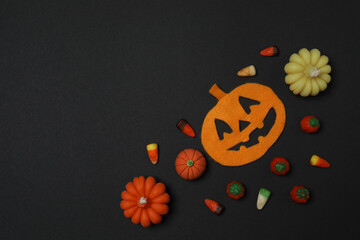 Halloween with skull, ticks, orange maple leaves, bats, spiders on black background with space for...
