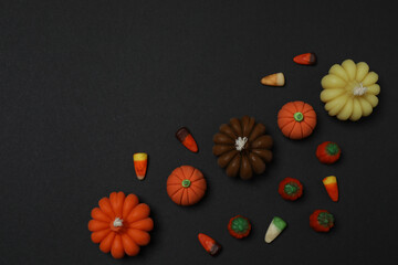 Halloween with skull, ticks, orange maple leaves, bats, spiders on black background with space for...