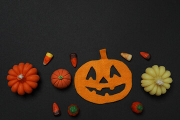 Halloween with skull, ticks, orange maple leaves, bats, spiders on black background with space for...
