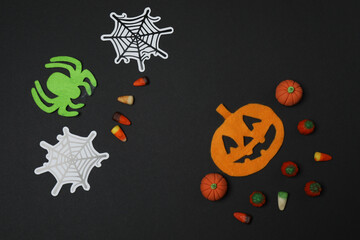 Halloween with skull, ticks, orange maple leaves, bats, spiders on black background with space for...