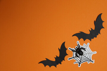 Halloween with skull, ticks, orange maple leaves, bats, spiders on orange background with space for...