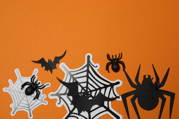 Halloween with skull, ticks, orange maple leaves, bats, spiders on orange background with space for...