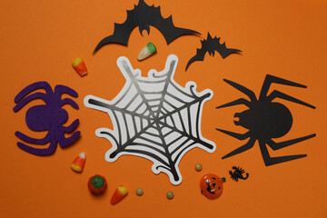 Halloween with skull, ticks, orange maple leaves, bats, spiders on orange background with space for...