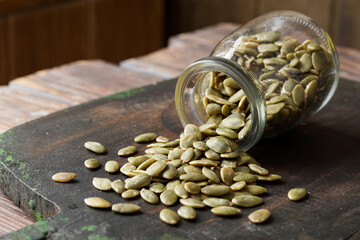 Close-Up of Raw Pumpkin Seeds or Pepitas on Rustic Surface as a Nutritious Plant-Based Snack