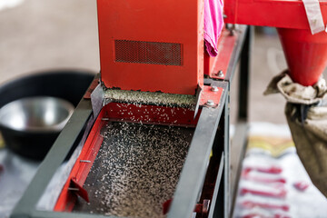 The rice is milled by a rice mill machine.