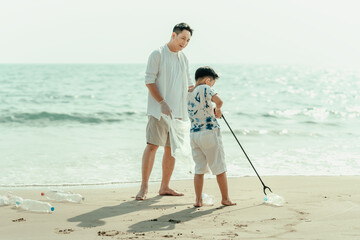 On the beach, a father and son carry bags to collect trash. Clean up the dirty sea or ocean and...
