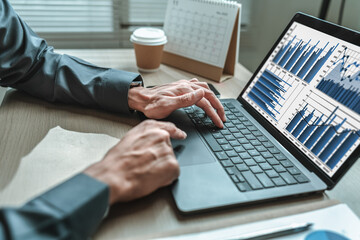 Businessman is hand working and typing on laptop. Business, corporate and finance concept.
