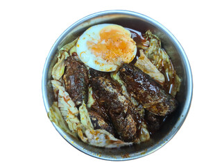 Fried mackerel fish with spicy sauce served with boiled egg and boiled vegetables in a stainless steel bowl isolated on white background