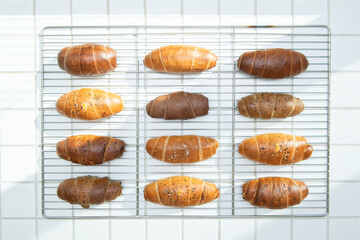 Assortment of Freshly Baked Bread Rolls on a Cooling Rack