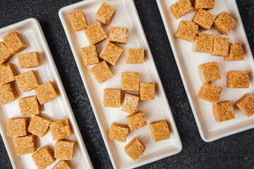 Cubes of sweet confectionery displayed on elegant plates in a modern setting