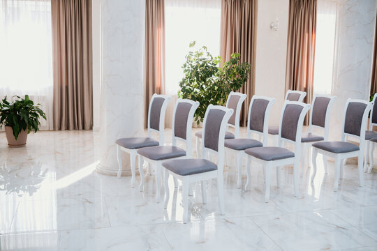 Elegant seating arrangement in a bright indoor event space with natural light