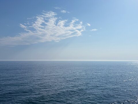 Calm ocean and cloud in the blue sky.