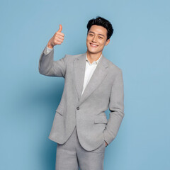 Confident Young Asian Businessman Giving Thumbs Up in a Studio Generating AI