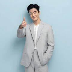 Confident Young Asian Businessman Giving Thumbs Up in a Studio Generating AI