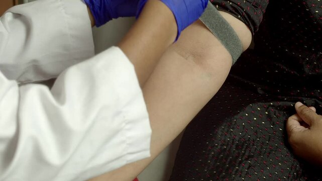 An Indian young woman giving a blood sample