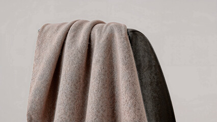 Cozy woolen scarf gracefully draped over chair