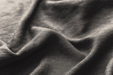 Black fabric with wrinkles close up eco friendly textile concept