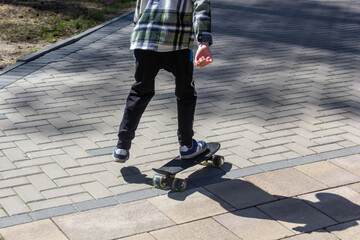 child riding a steak in the park, skateboarding, summer vacation in the park, boy riding a skateboard close-up © Natali Osa