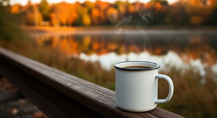Cozy steaming coffee mug on rustic wood, with a beautiful autumn lake view.

