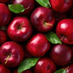 A close-up overhead shot of numerous shiny, dark red apples nestled together, interspersed with vibrant green leaves