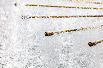 A series of bamboo sticks are floating in a stream of water