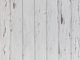The image is of a white wooden surface with a lot of peeling paint