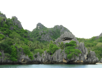 Jagged limestone cliffs with lush green vegetation isolated on transparent background