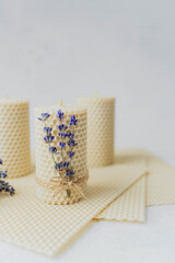 Handmade beeswax candles decorated with lavender close up