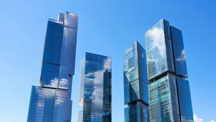 Fototapeta premium Cluster of Modern Glass Skyscrapers Reflecting Blue Sky in Urban Skyline