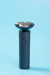 Man electric shaver on blue background