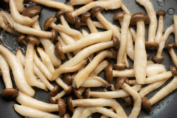 Stir Fried Brown Beech Mushrooms On Frying Pan With Oil.