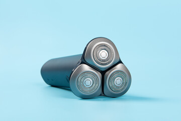Man electric shaver on blue background