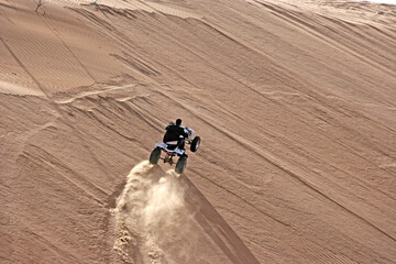ATV Rider Navigating Sand Dunes In Oman