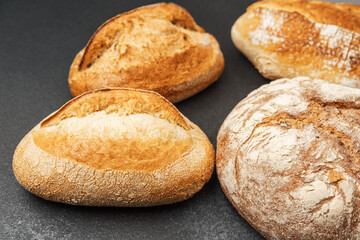 Freshly baked artisan bread on a dark countertop ready to be served